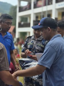 Nawaraj Bhandari handing out clothing to flood survivors